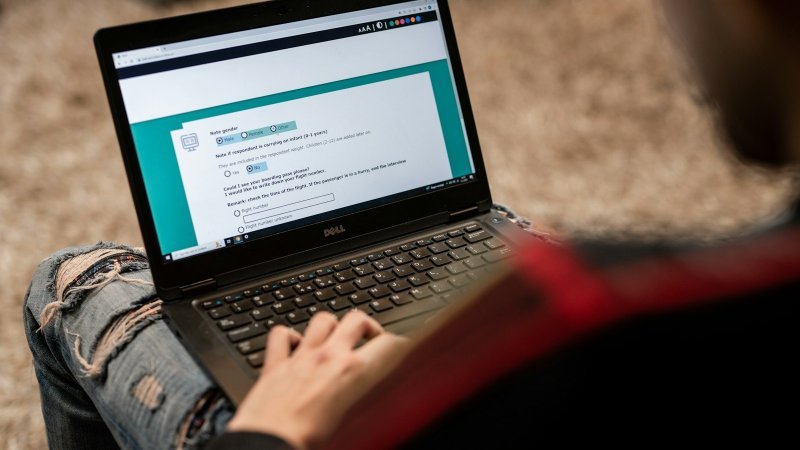 Researcher learning how to conduct a pilot study for graduate research using a laptop